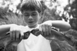 Busy boy with trout cought that day. Portrait Photographer Anita Nowacka