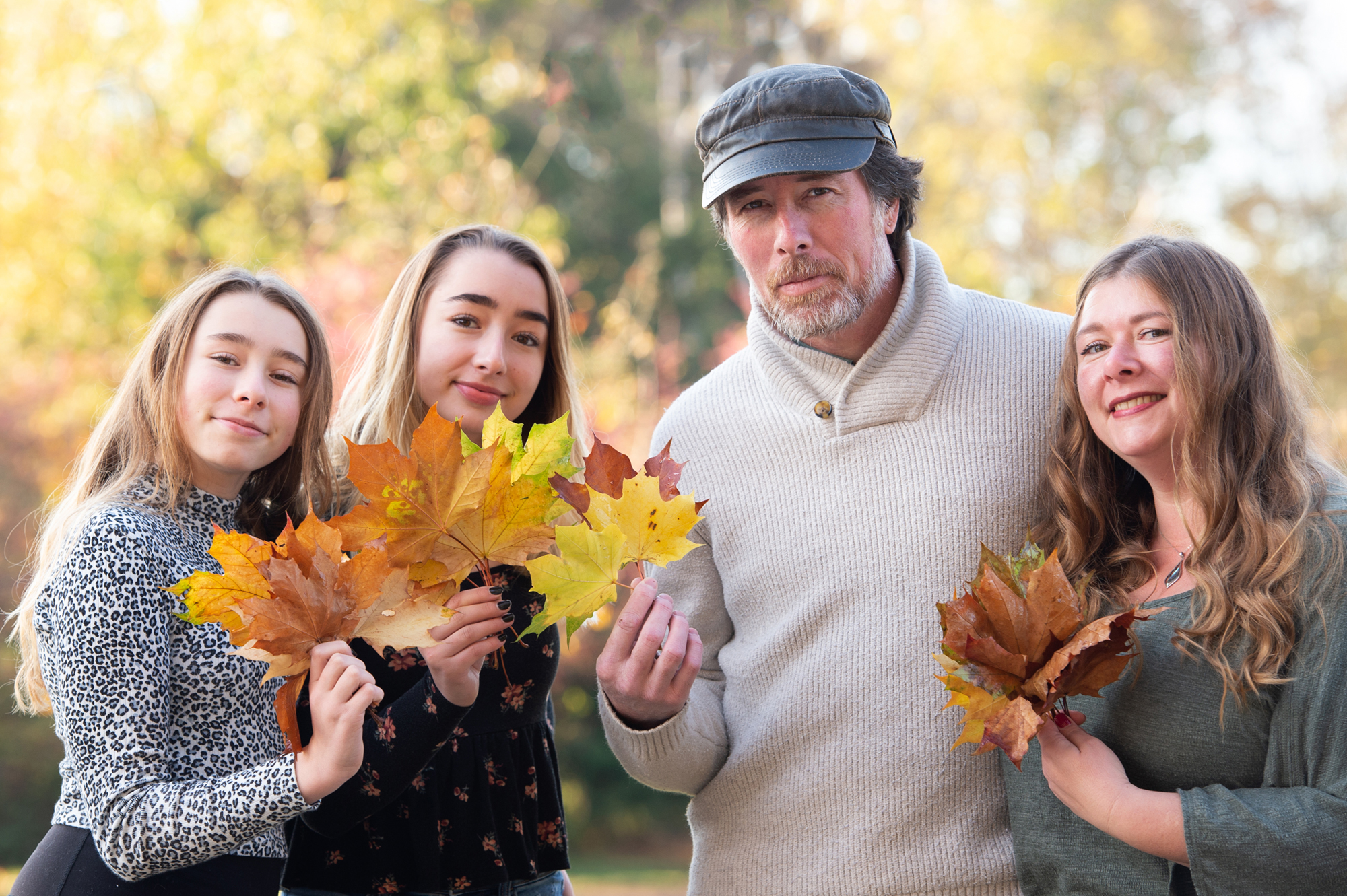 Family holding Autumn leaves